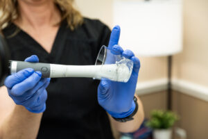 A provider wearing glovers prepares the applicator of the Emfemme device for urinary incontinence treatment near The Villages, FL.