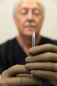 A man prepares treatment for Semaglutide in Ocala