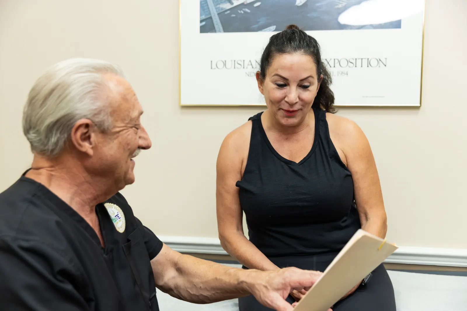 A provider and a patient in a black shirt discuss medical weight loss in Ocala.